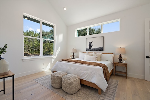 bedroom featuring vaulted ceiling and light hardwood / wood-style flooring