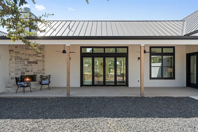 exterior space featuring ceiling fan, a patio area, and exterior fireplace