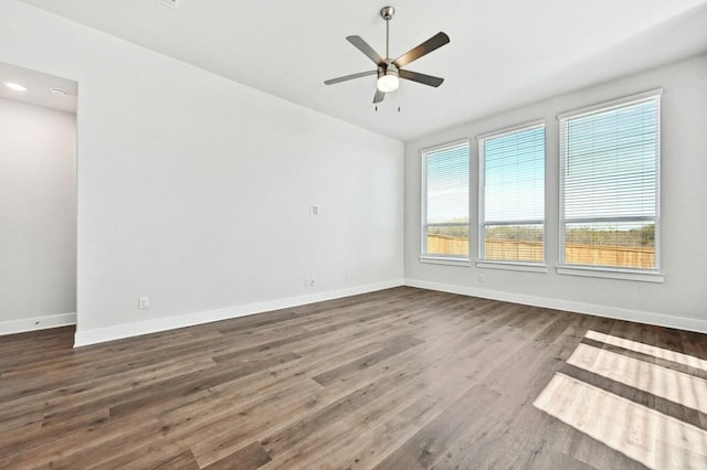 unfurnished room with ceiling fan and dark wood-type flooring