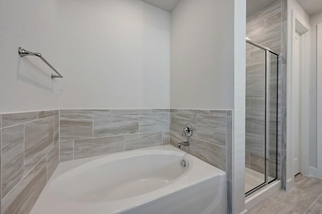 bathroom featuring separate shower and tub