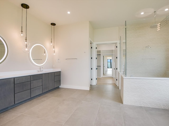 bathroom with vanity, tile patterned flooring, and tiled shower