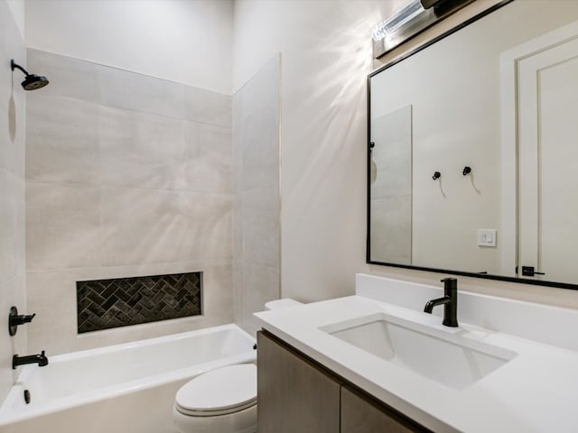 full bathroom featuring vanity, tiled shower / bath combo, and toilet