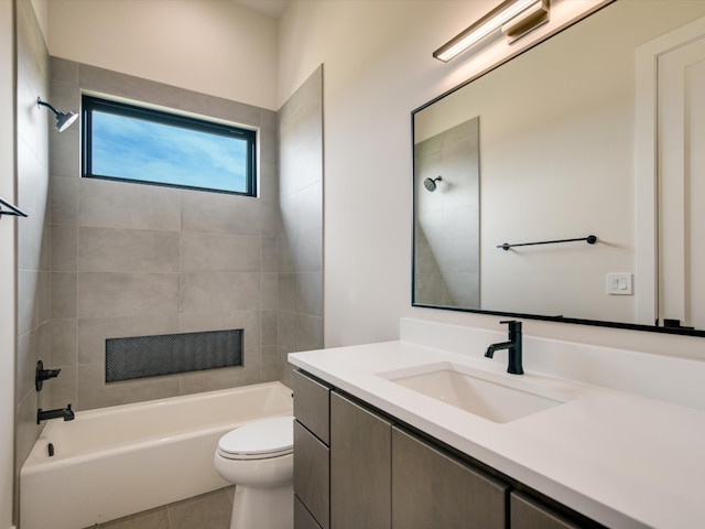 full bathroom with vanity, toilet, tile patterned floors, and tiled shower / bath combo