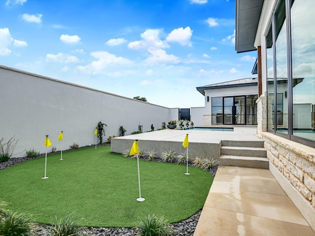 view of yard with a patio and a pool