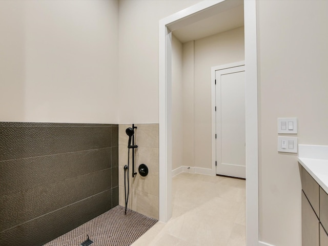 bathroom with vanity and tiled shower