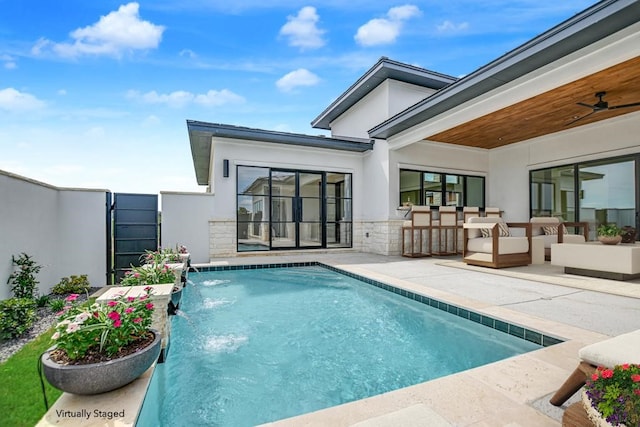 view of swimming pool featuring a patio area, pool water feature, outdoor lounge area, and ceiling fan