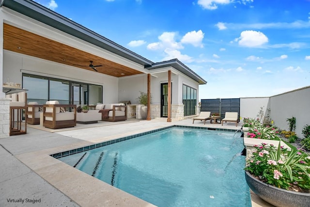 view of swimming pool featuring a patio, an outdoor living space, pool water feature, and ceiling fan