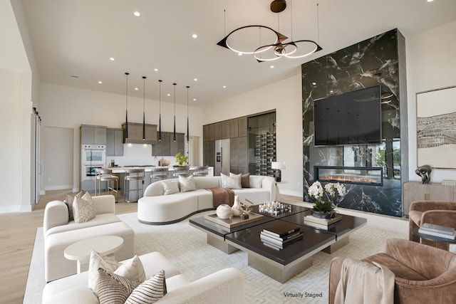 living room with a fireplace and light wood-type flooring