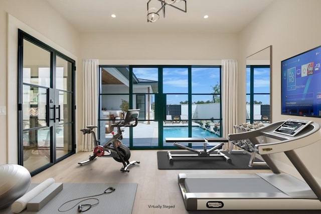 exercise room with wood-type flooring