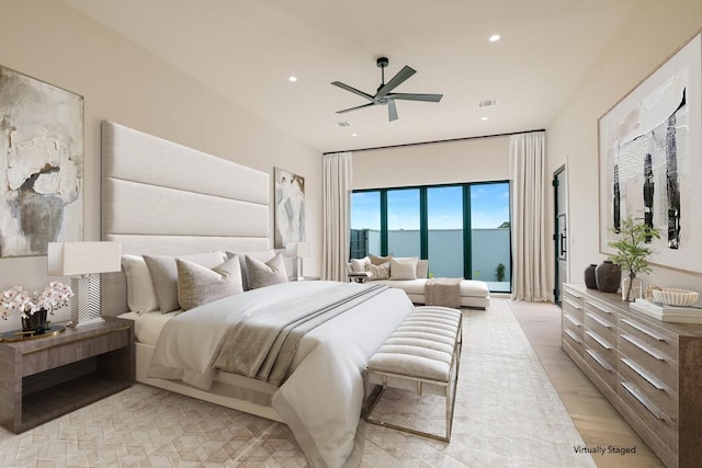 bedroom featuring a water view, ceiling fan, and light wood-type flooring