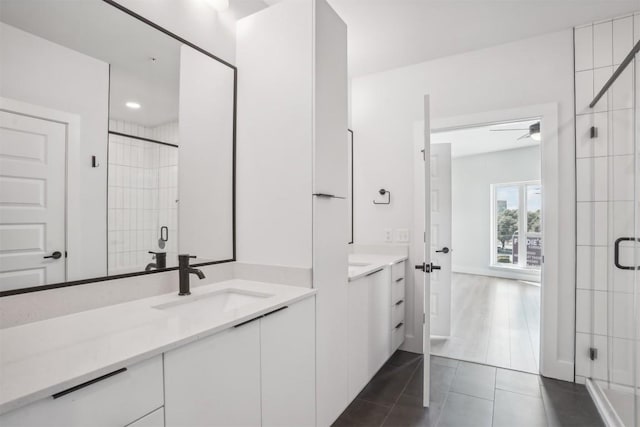 bathroom featuring tile patterned flooring, vanity, an enclosed shower, and ceiling fan