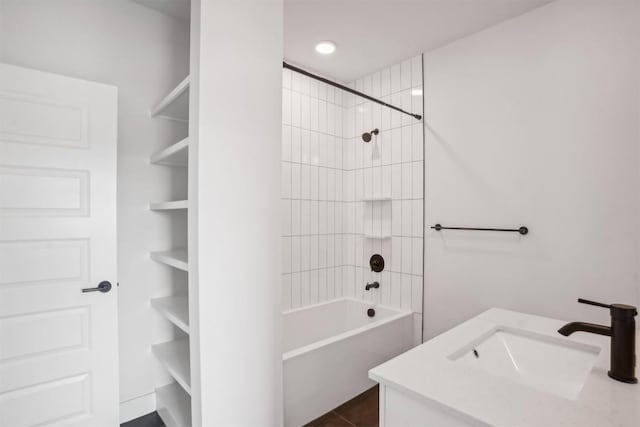 bathroom with tile patterned floors, tiled shower / bath combo, and vanity