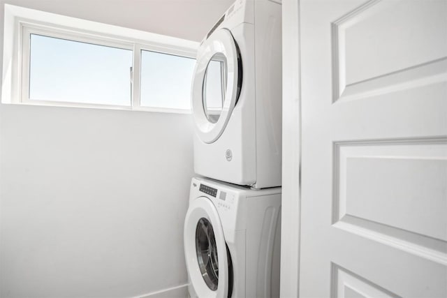 laundry area featuring stacked washer / drying machine