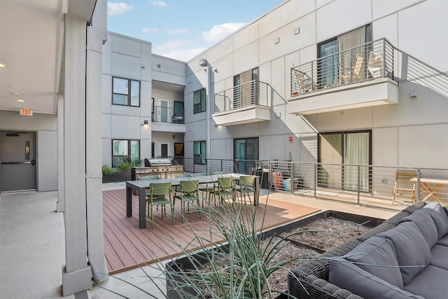 deck featuring a grill and an outdoor hangout area