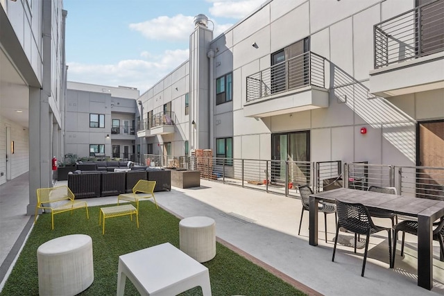 surrounding community featuring an outdoor hangout area and a patio area