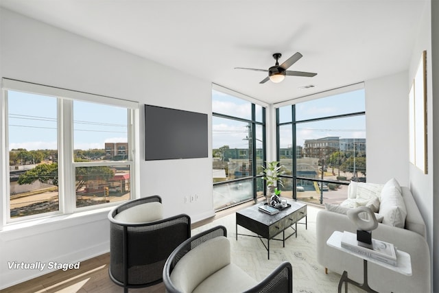 living room featuring hardwood / wood-style flooring, ceiling fan, and a healthy amount of sunlight