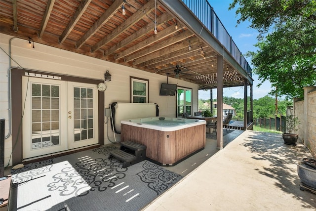 view of patio with a hot tub, french doors, and ceiling fan