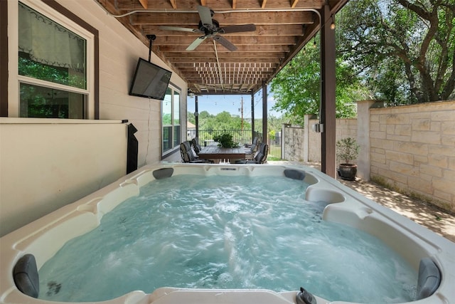 view of swimming pool with a hot tub and ceiling fan