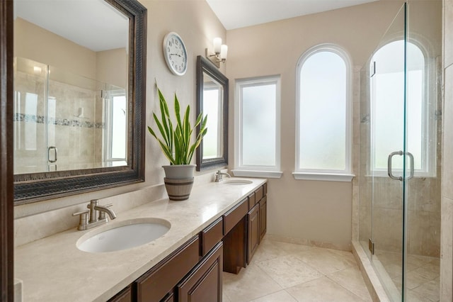 bathroom featuring walk in shower, vanity, and tile patterned flooring