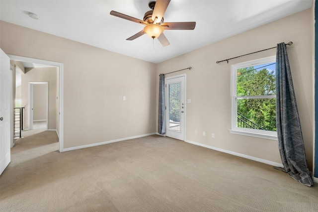 carpeted empty room with ceiling fan