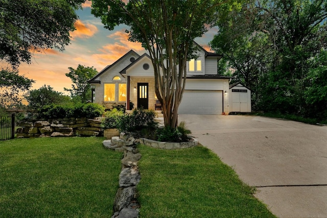 view of front of house with a garage and a lawn