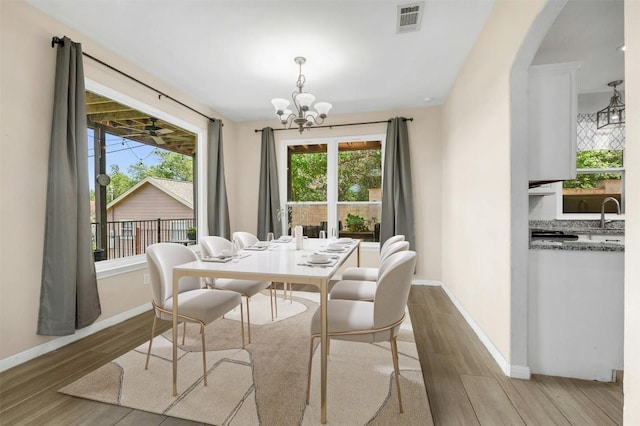 dining area with a notable chandelier and a wealth of natural light