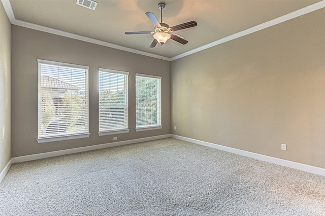 spare room with carpet flooring, ceiling fan, and crown molding