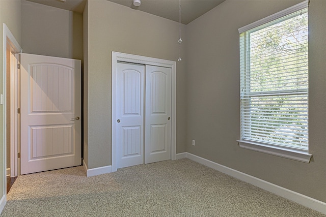 unfurnished bedroom featuring a closet and carpet floors