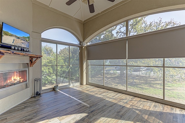 unfurnished sunroom featuring a wealth of natural light and ceiling fan