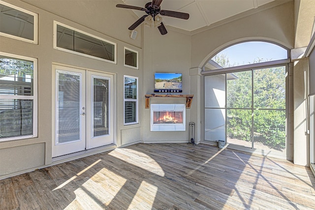 unfurnished sunroom featuring french doors and ceiling fan