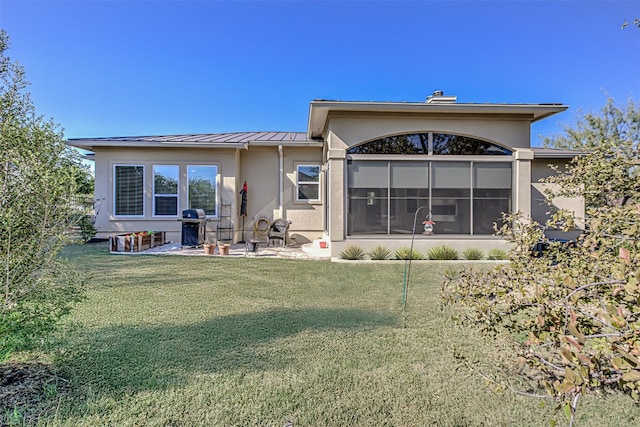 back of property featuring a yard and a patio area