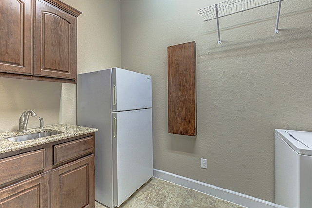 laundry room featuring washer / clothes dryer and sink