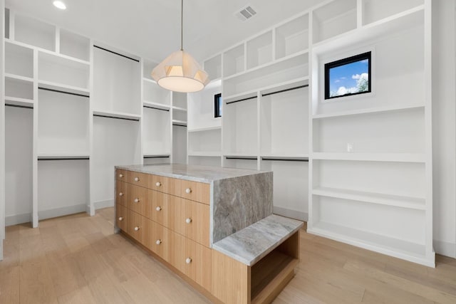 spacious closet featuring light hardwood / wood-style floors