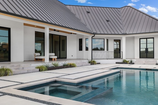 view of swimming pool featuring an in ground hot tub and a patio area