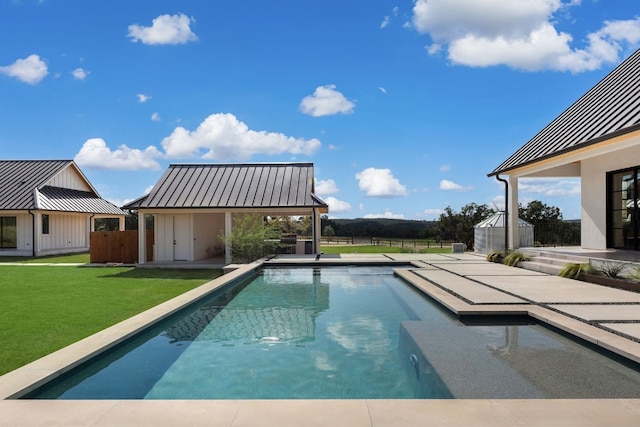 view of swimming pool featuring a shed, a lawn, and a patio area