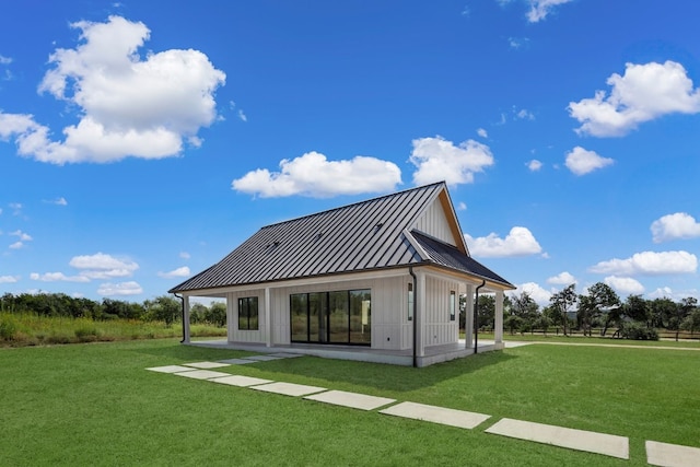 rear view of property with a patio and a yard