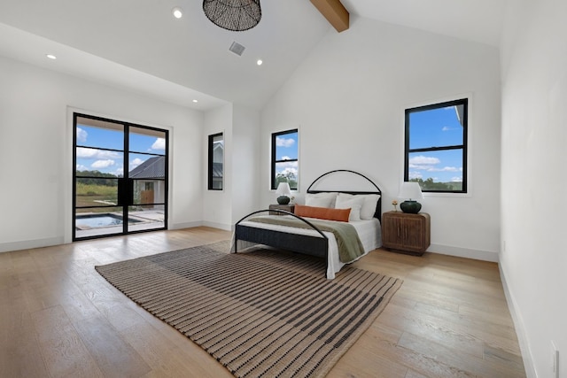 bedroom with light wood-type flooring, access to exterior, multiple windows, and beamed ceiling