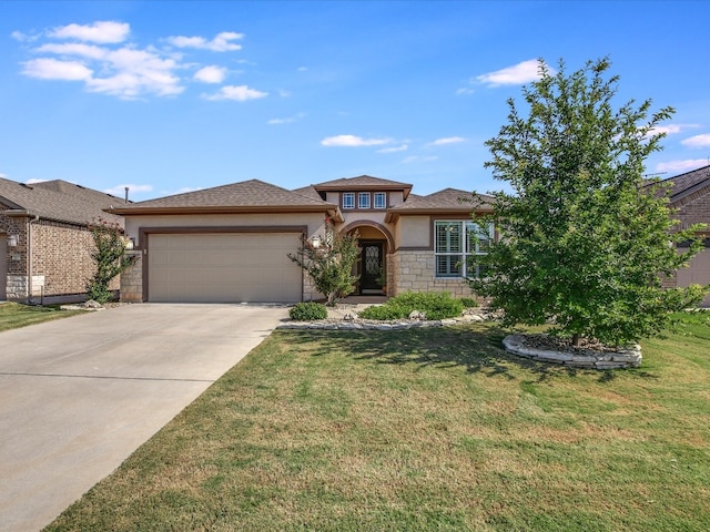 prairie-style house featuring a front yard and a garage