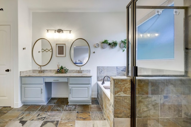 bathroom featuring vanity and tiled bath