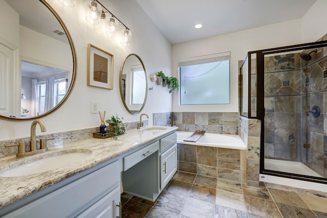 bathroom featuring vanity and separate shower and tub