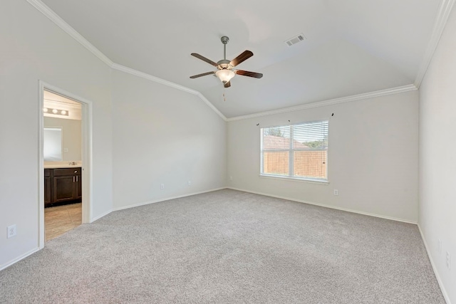 carpeted spare room featuring lofted ceiling, ornamental molding, and ceiling fan