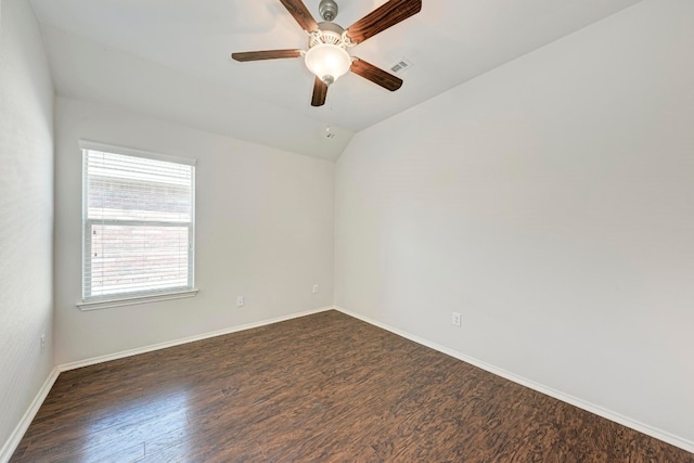 empty room with ceiling fan, dark wood-type flooring, and vaulted ceiling