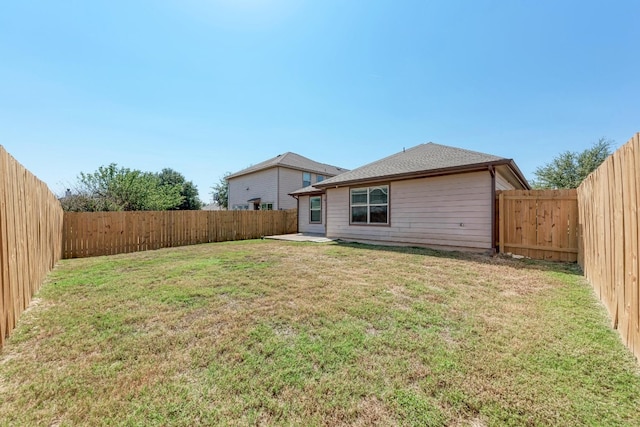 back of house with a lawn