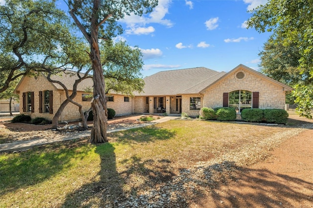 ranch-style home featuring a front yard