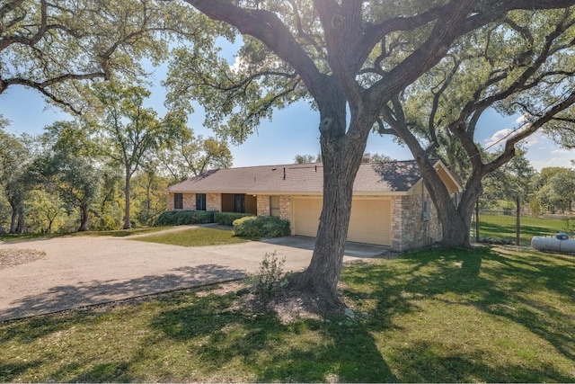 single story home with a garage and a front yard