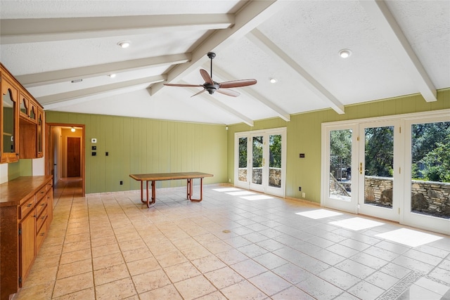 game room with lofted ceiling with beams, wood walls, a textured ceiling, and a ceiling fan