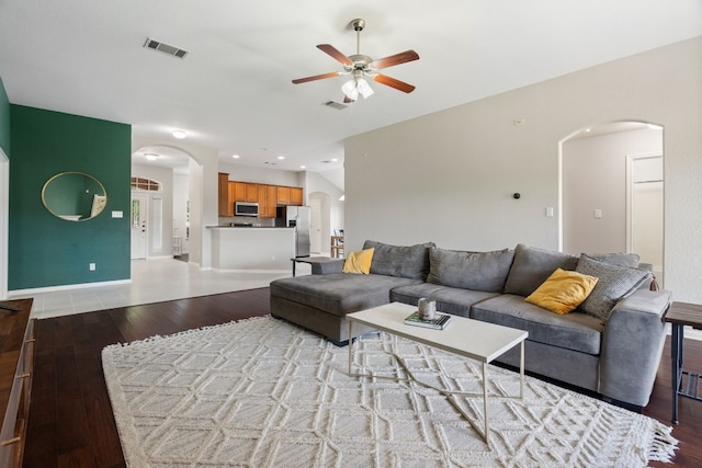 living room with light hardwood / wood-style flooring and ceiling fan