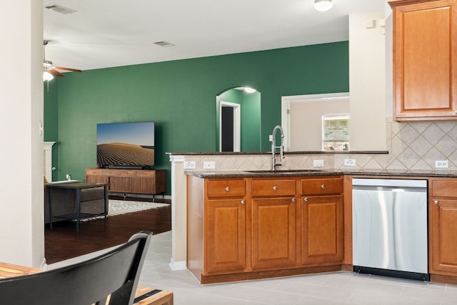 kitchen featuring dishwasher, light tile patterned flooring, ceiling fan, and sink