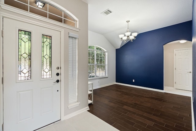 foyer entrance with lofted ceiling and a chandelier