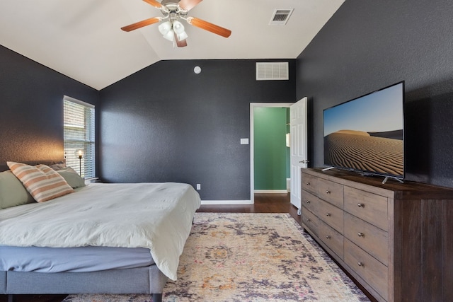 bedroom with dark hardwood / wood-style floors, ceiling fan, and lofted ceiling